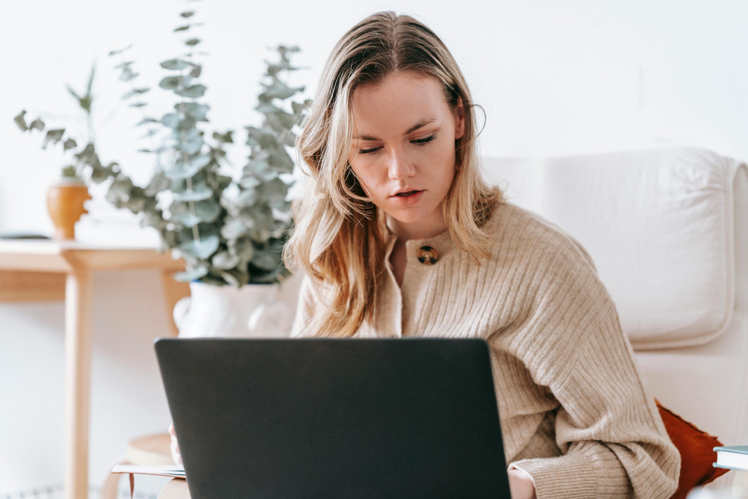 How to Avoid Remote Work Scams When Searching for Remote Work: Picture of a lady working remotely on a laptop
